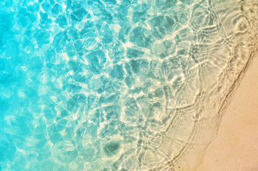 The summer beach with sand and wave.