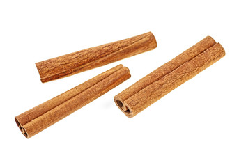 Three cinnamon sticks on a white background