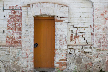Large brown wooden door on a white wall