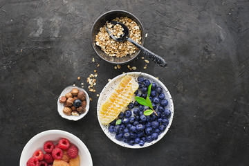 Ingredients for healthy breakfast meals: raspberries, blueberries, nuts, orange, bananas, grapes blue, green, apples, kiwi. Top View.