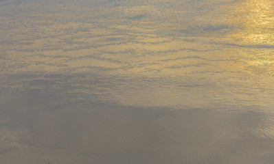 Surface water along the shoreline with glare on the surface and