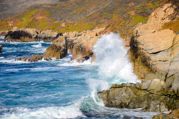Huge wave breaking on cliffs along the beautiful Pacific Coast Highway in California at Garrapata State Park in Big Sur near Carmel and Monterey