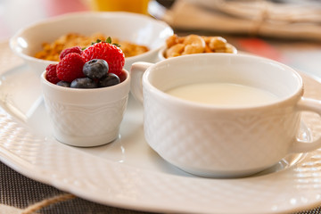 Healthy breakfast. Fresh juice, granola, muesli with milk and berries