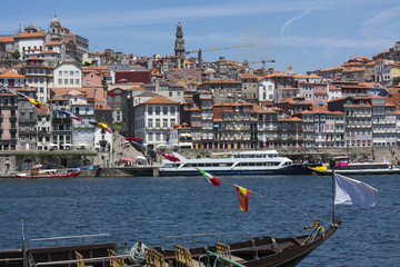 Part of the city of Porto with a traditional cargo ship in the foreground