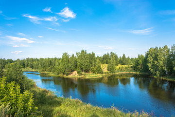 Naklejka na ściany i meble Landscape with a small lake on a summer day.