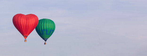 Fototapeta na wymiar Colorful hot-air balloons flying in the sky, banner