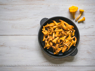 Chanterelle mushrooms fried in cast iron frying pan.
