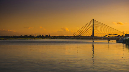 Fototapeta na wymiar Suspension bridge over the Martwa Wisla in Gdansk at sunset