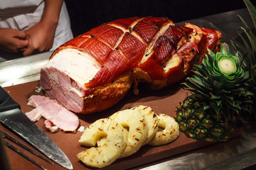 chef ready to slice honey glazed roasted ham pork for guests on holidays, celebration event. Gala Dinner, Buffet, Feast, Party, Celebration, Anniversary Luxury meal, holiday and festivals concept.