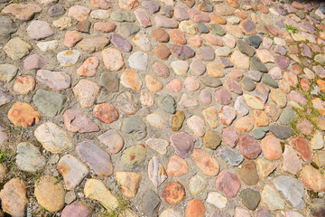 Cobblestone pavement near the church of St. George the Victorious in Kolomenskoye. Russia, Moscow, August 2018.