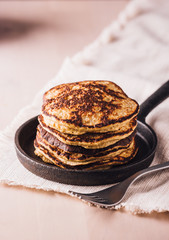 Pile of homemade pancakes freshly made on a small pan