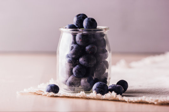 Close view of fresh blueberries in a glass jar