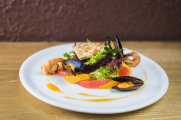 salad of seafood and citrus, on a white plate