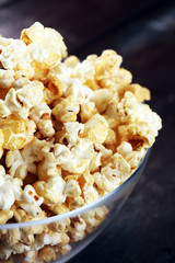 Cinema concept with popcorn on rustic table