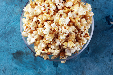 Cinema concept with popcorn on rustic table