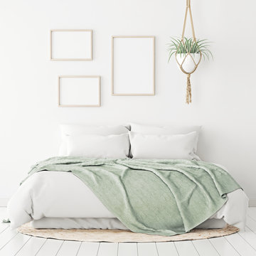 Poster mockup with three frames composition on empty white wall in bedroom interior with bed, green plaid, rug and plant. 3D rendering.