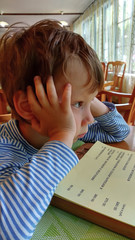The boy chooses food in a restaurant