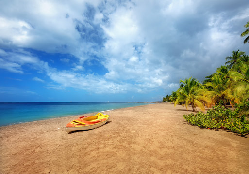 Travel Caribbeans. Beautiful Beach in Martinique Island. Small boat on the beach. Grande Anse Le Coin Beach, Le Carbet.