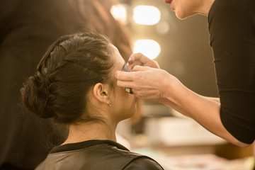 Young women doing makeup , old-fashioned. Backstage.