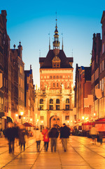 Golden gate in old town at night, Gdansk, Poland, retro toned