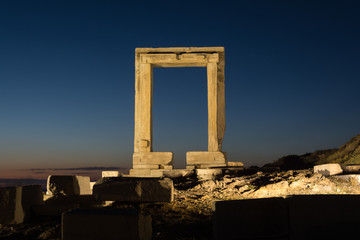 The remains of the ancient temple of Delian Apollo, also called Portara, at dusk, at Naxos island, Greece