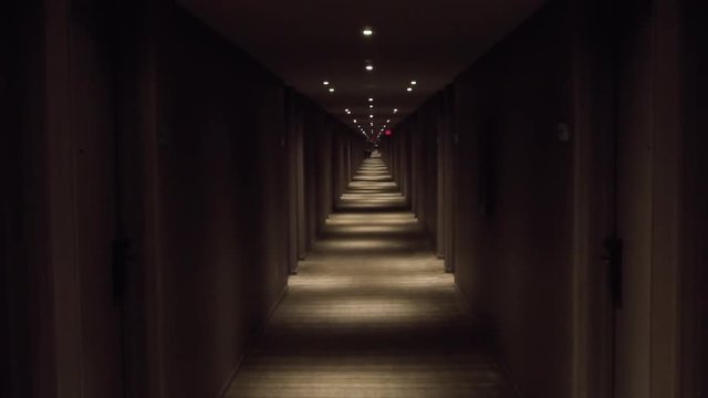 View down a long dark hotel hallway