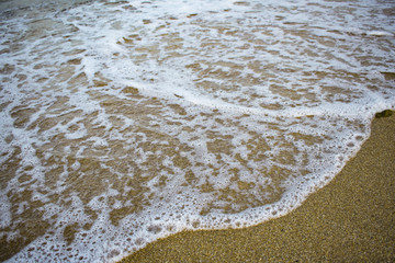 wave surf on the sandy beach