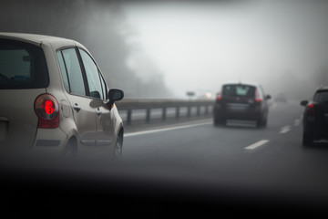 Fototapeta na wymiar Cars going fast on a highway