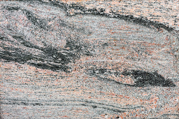 Granite plate with black spots on a red background