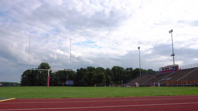 Empty High School football stadium wide, behind the goal post.