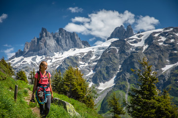 Fototapeta na wymiar Pretty, female hiker/climber in a lovely alpine setting of Swiss Alps