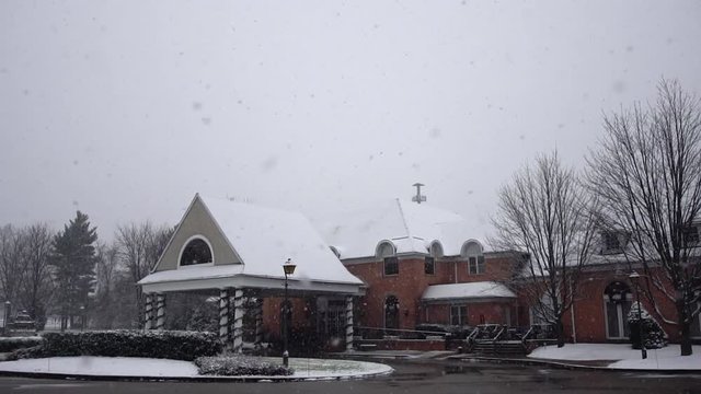 Exterior of a country club in a snow storm, in slow motion