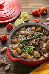 Thai Beef Massaman Curry served in big red pot, top view