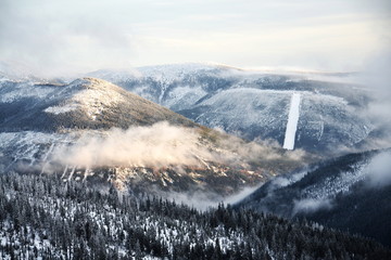 Beautiful snowy foggy winter landscape of Labsky dul, Elbe valley near Elbe river spring, country near Labska bouda, Krkonose Mountains, Czech Republic, freezing weather