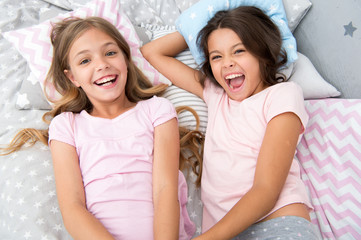 pajama party and friendship. pajama party of two happy small kids in bedroom. friendship of small...