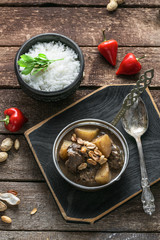 Thai Beef Massaman Curry with Rice, dark background copy space