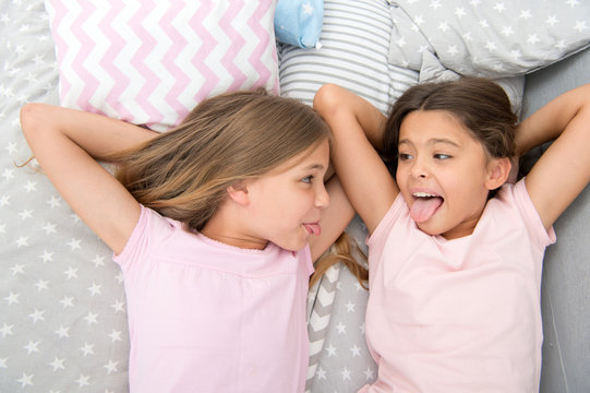 parenting and family relations of happy small girls in bedroom. family and parenting concept. small girls have fun. always happy together.