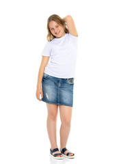 Little school girl pointing to her empty white t-shirt.