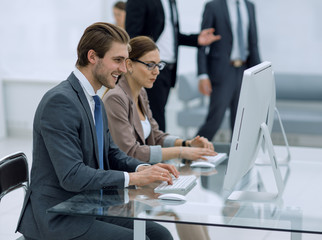 employees sitting at a Desk in the Bank office