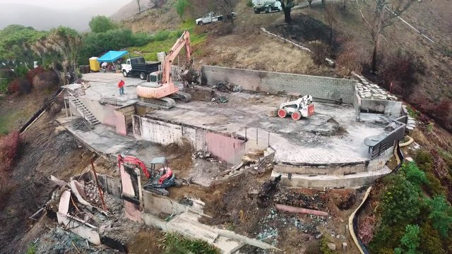 Aerial of a house being bulldozed on a hillside in Ventura following the destruction of Thomas Fire.