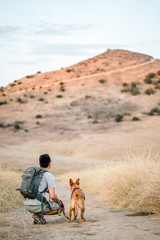man and dog hiking