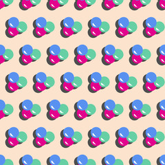 colorful wobbly bubbles with drop shadow on pastel pink background