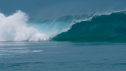 Fototapeta premium CLOSE UP: Forceful barrel wave splashes ocean water around the coast of Tahiti.