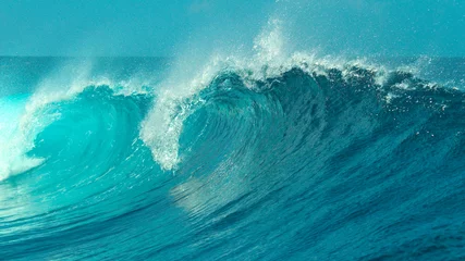 Tuinposter CLOSE UP: Glimmering barrel wave rushes past the camera on a sunny day in Tahiti © helivideo
