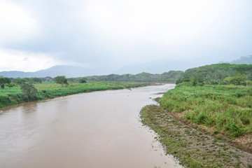 the brown river in the middle of the landscape