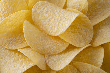 Golden crispy potato chips snack texture background. Close up. Banner. Horizontal.