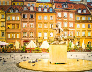 Fototapeta na wymiar Medieval Fountain of Mermaid and houses on Old Town Market square in Warsaw, capital of Poland, retro toned
