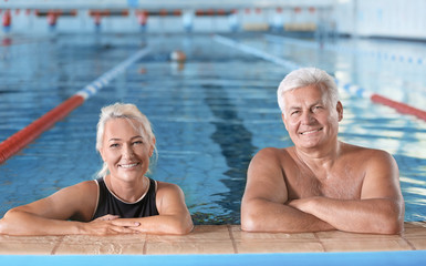 Fototapeta premium Sportive senior couple in indoor swimming pool