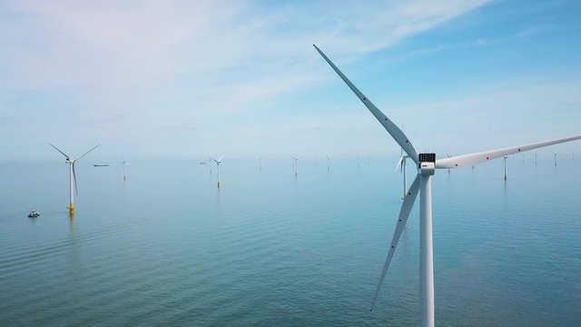 Remarkable drone aerial over windmills and turbines in the ocean off the coast of England.