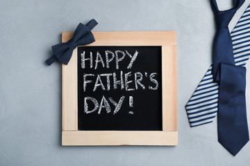 Flat lay composition with blackboard and ties on gray background. Happy Father's Day